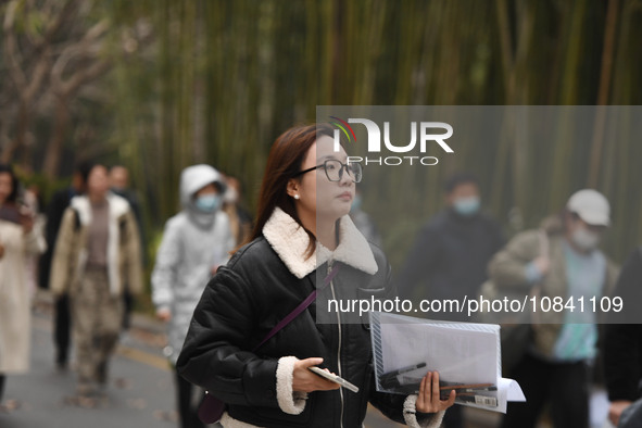 Candidates are waiting to enter the written exam of the Jiangsu 2024 civil servant exam in Nanjing, Jiangsu Province, China, on December 10,...