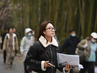 Candidates are waiting to enter the written exam of the Jiangsu 2024 civil servant exam in Nanjing, Jiangsu Province, China, on December 10,...