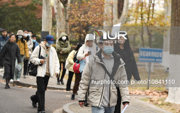 Candidates are waiting to enter the written exam of the Jiangsu 2024 civil servant exam in Nanjing, Jiangsu Province, China, on December 10,...