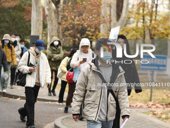 Candidates are waiting to enter the written exam of the Jiangsu 2024 civil servant exam in Nanjing, Jiangsu Province, China, on December 10,...