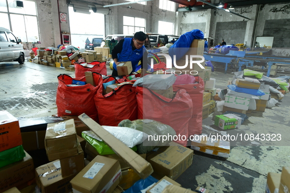 Workers are sorting items to be delivered at an express delivery company in Taicang, Jiangsu Province, China, on December 11, 2023. 