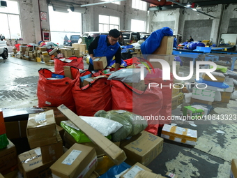 Workers are sorting items to be delivered at an express delivery company in Taicang, Jiangsu Province, China, on December 11, 2023. (