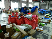 Workers are sorting items to be delivered at an express delivery company in Taicang, Jiangsu Province, China, on December 11, 2023. (