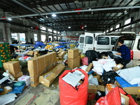 Workers are sorting items to be delivered at an express delivery company in Taicang, Jiangsu Province, China, on December 11, 2023. (