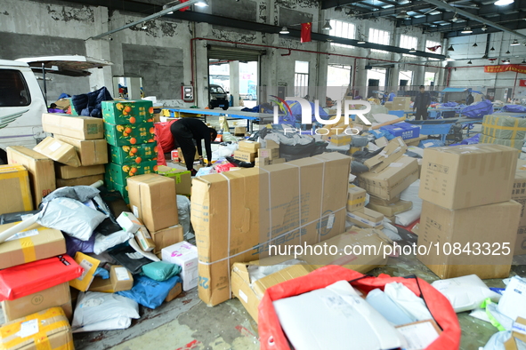 Workers are sorting items to be delivered at an express delivery company in Taicang, Jiangsu Province, China, on December 11, 2023. 