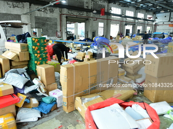 Workers are sorting items to be delivered at an express delivery company in Taicang, Jiangsu Province, China, on December 11, 2023. (