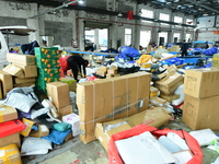 Workers are sorting items to be delivered at an express delivery company in Taicang, Jiangsu Province, China, on December 11, 2023. (