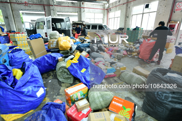 Workers are sorting items to be delivered at an express delivery company in Taicang, Jiangsu Province, China, on December 11, 2023. 