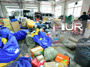 Workers are sorting items to be delivered at an express delivery company in Taicang, Jiangsu Province, China, on December 11, 2023. (