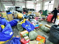 Workers are sorting items to be delivered at an express delivery company in Taicang, Jiangsu Province, China, on December 11, 2023. (