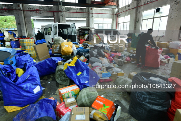 Workers are sorting items to be delivered at an express delivery company in Taicang, Jiangsu Province, China, on December 11, 2023. 