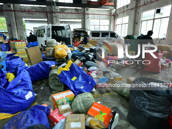 Workers are sorting items to be delivered at an express delivery company in Taicang, Jiangsu Province, China, on December 11, 2023. (