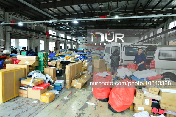 Workers are sorting items to be delivered at an express delivery company in Taicang, Jiangsu Province, China, on December 11, 2023. 