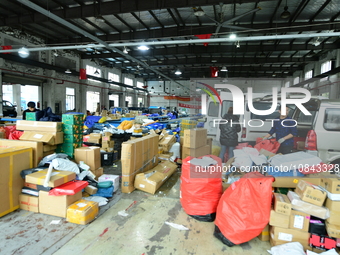 Workers are sorting items to be delivered at an express delivery company in Taicang, Jiangsu Province, China, on December 11, 2023. (