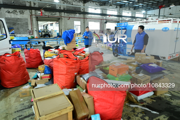 Workers are sorting items to be delivered at an express delivery company in Taicang, Jiangsu Province, China, on December 11, 2023. 