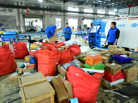 Workers are sorting items to be delivered at an express delivery company in Taicang, Jiangsu Province, China, on December 11, 2023. (