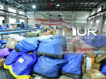 Workers are sorting items to be delivered at an express delivery company in Taicang, Jiangsu Province, China, on December 11, 2023. (