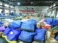 Workers are sorting items to be delivered at an express delivery company in Taicang, Jiangsu Province, China, on December 11, 2023. (