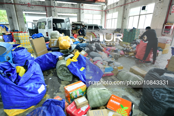 Workers are sorting items to be delivered at an express delivery company in Taicang, Jiangsu Province, China, on December 11, 2023. 