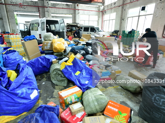 Workers are sorting items to be delivered at an express delivery company in Taicang, Jiangsu Province, China, on December 11, 2023. (