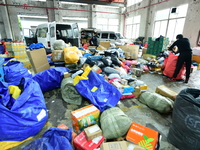 Workers are sorting items to be delivered at an express delivery company in Taicang, Jiangsu Province, China, on December 11, 2023. (