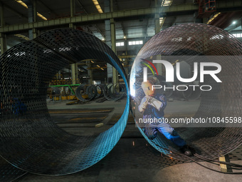 A worker is welding steel components of an air separation plant in Huzhou, Zhejiang Province, China, on December 12, 2023. (