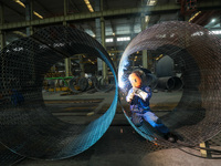 A worker is welding steel components of an air separation plant in Huzhou, Zhejiang Province, China, on December 12, 2023. (