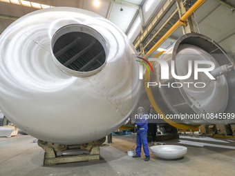 A worker is producing air separation equipment for export to Turkey in Huzhou, Zhejiang Province, China, on December 12, 2023. (