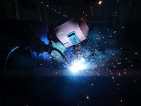 A worker is welding steel components of air separation equipment in Huzhou, Zhejiang Province, China, on December 12, 2023. (