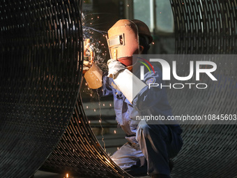 A worker is welding steel components of air separation equipment in Huzhou, Zhejiang Province, China, on December 12, 2023. (