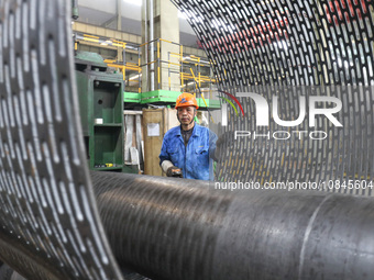 A worker is producing air separation equipment for export to Turkey in Huzhou, Zhejiang Province, China, on December 12, 2023. (