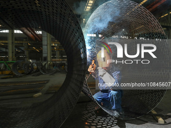 A worker is welding steel components of air separation equipment in Huzhou, Zhejiang Province, China, on December 12, 2023. (