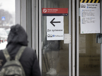 An arrow is pointing at a public transport stop for the Lybidska metro station, which is operating between the closed metro stations of the...