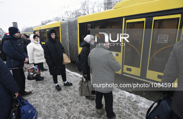 Passengers are facing a bus that is running between the closed metro stations of the Blue Line in Kyiv, Ukraine, on December 11, 2023. Train...