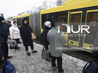 Passengers are facing a bus that is running between the closed metro stations of the Blue Line in Kyiv, Ukraine, on December 11, 2023. Train...