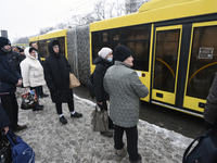 Passengers are facing a bus that is running between the closed metro stations of the Blue Line in Kyiv, Ukraine, on December 11, 2023. Train...