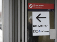 An arrow is pointing at a public transport stop for the Lybidska metro station, which is operating between the closed metro stations of the...