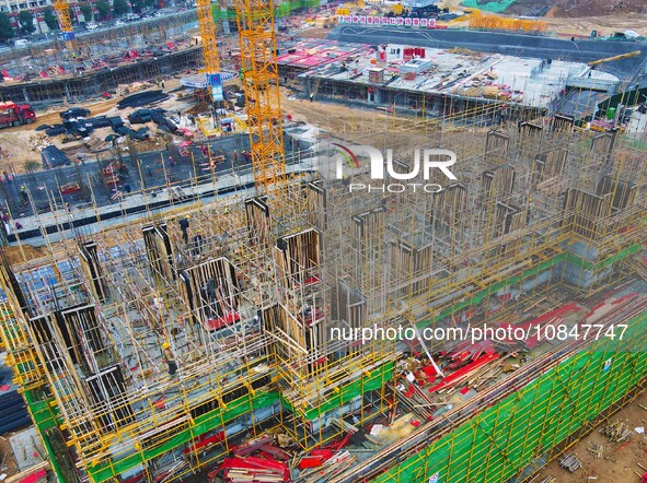 Workers are stepping up construction at the resettlement area project site in Yuexi County, Anqing City, Anhui Province, China, on December...