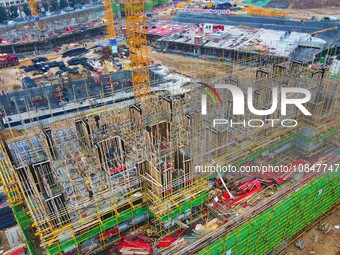 Workers are stepping up construction at the resettlement area project site in Yuexi County, Anqing City, Anhui Province, China, on December...