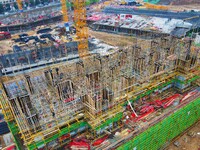 Workers are stepping up construction at the resettlement area project site in Yuexi County, Anqing City, Anhui Province, China, on December...