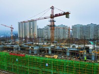 Workers are stepping up construction at the resettlement area project site in Yuexi County, Anqing City, Anhui Province, China, on December...