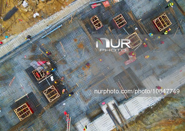 Workers are stepping up construction at the resettlement area project site in Yuexi County, Anqing City, Anhui Province, China, on December...