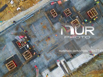 Workers are stepping up construction at the resettlement area project site in Yuexi County, Anqing City, Anhui Province, China, on December...