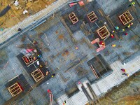 Workers are stepping up construction at the resettlement area project site in Yuexi County, Anqing City, Anhui Province, China, on December...