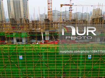 Workers are stepping up construction at the resettlement area project site in Yuexi County, Anqing City, Anhui Province, China, on December...