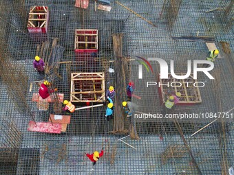 Workers are stepping up construction at the resettlement area project site in Yuexi County, Anqing City, Anhui Province, China, on December...