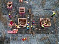 Workers are stepping up construction at the resettlement area project site in Yuexi County, Anqing City, Anhui Province, China, on December...