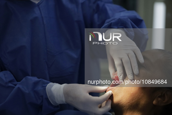 A dentist is performing tests with dental prostheses at the Centro de Odontogeriatria TIII Doctor Guillermo Roman y Carrillo Health Centre i...