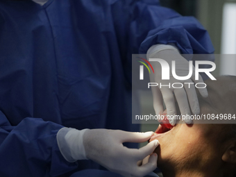 A dentist is performing tests with dental prostheses at the Centro de Odontogeriatria TIII Doctor Guillermo Roman y Carrillo Health Centre i...