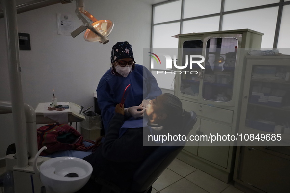 A dentist is performing tests with dental prostheses at the Centro de Odontogeriatria TIII Doctor Guillermo Roman y Carrillo Health Centre i...